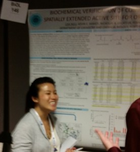 Lisa Ngu in front of poster