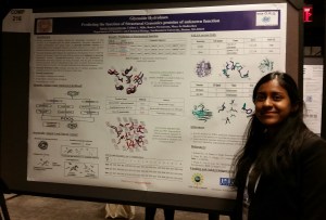 Saroja in front of poster